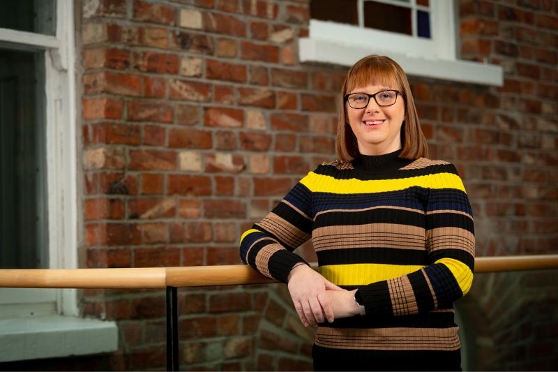 Dr Bronagh Byrne standing in the upper landing above the School of SSESW foyer