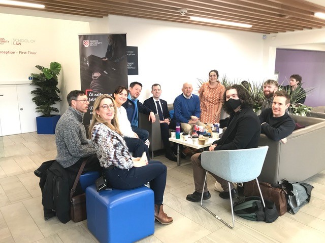 Image shows students and staff conversing in Irish in the foyer of the Main Site Tower.