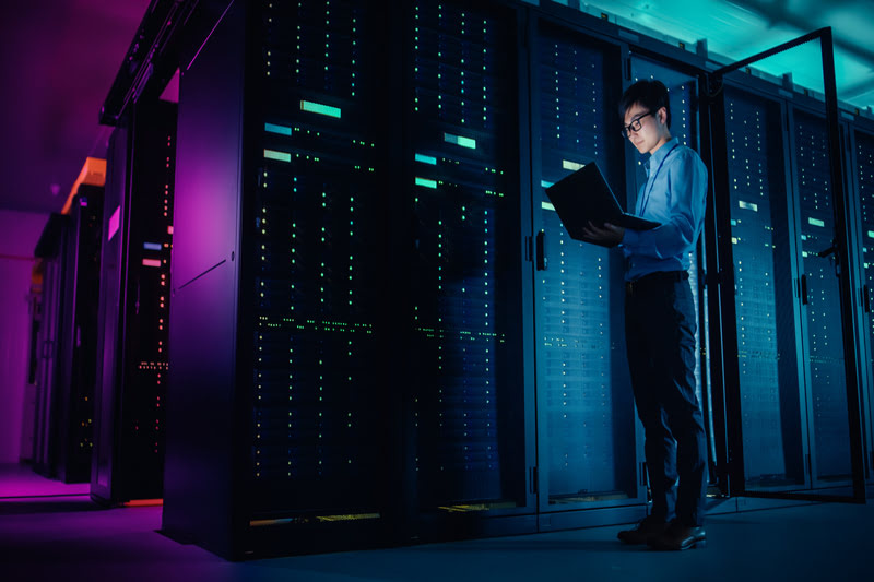 Man looking at laptop in data room
