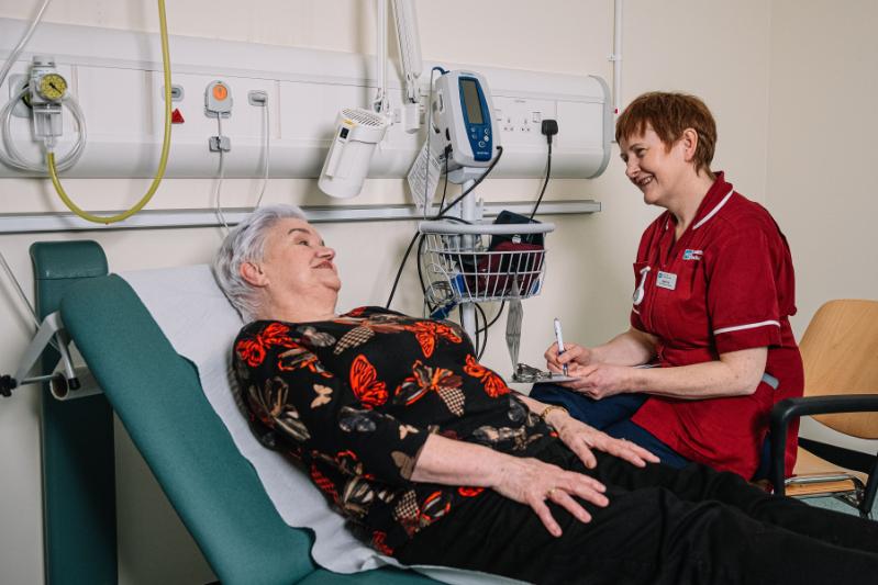 Clinical Trial participant on bed interacting with nurse