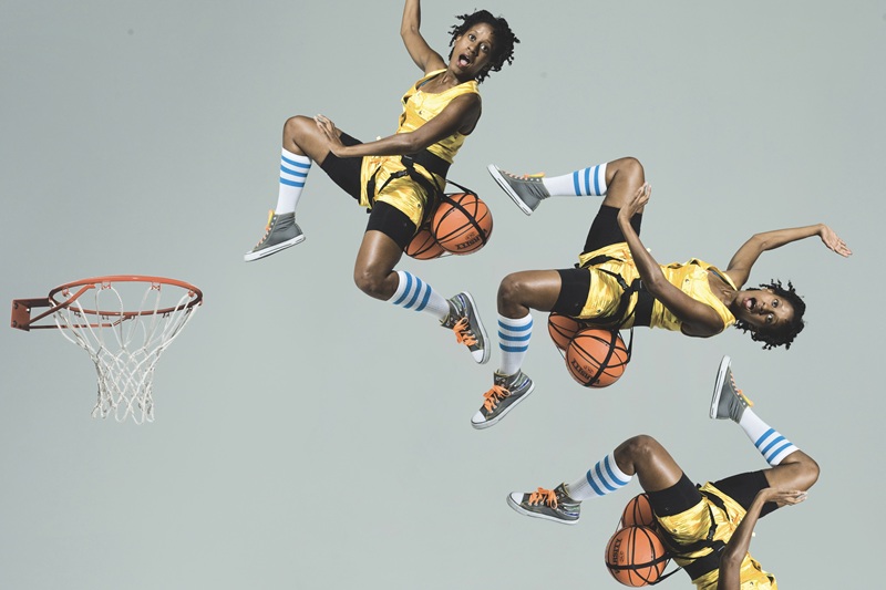 photographic exhibit showing in-motion shots of person in basketball gear and hoop jumping up to a basketball hoop